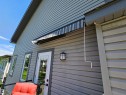 Exterior siding in a neutral tone with white trim - 2322 Rutherford Way, Edmonton, AB 