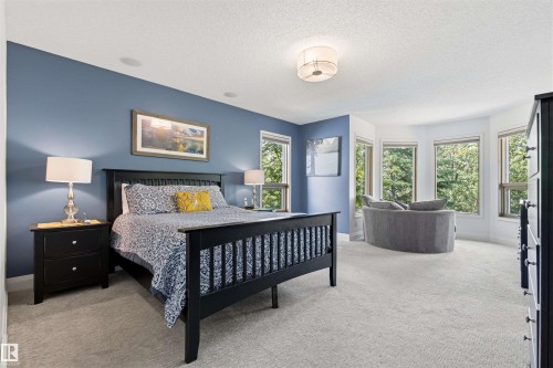 Carpeted room featuring a bed frame with a slatted headboard and footboard, recessed ceiling lighting, and a circular ceiling fixture - 624 Butchart Wynd, Edmonton, AB 
