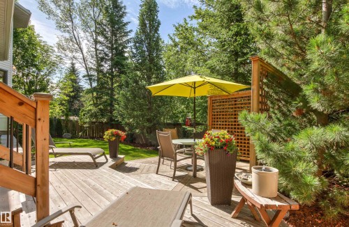 Multi-level wood deck featuring a lattice privacy screen and surrounding mature trees - 624 Butchart Wynd, Edmonton, AB 