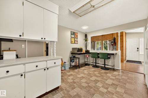 Kitchen featuring white cabinetry and a patterned floor - 24 Addison Crescent, St. Albert, AB 