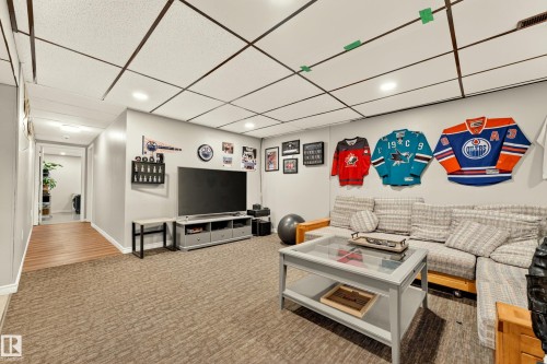 Spacious entertainment room featuring recessed lighting and a drop ceiling - 24 Addison Crescent, St. Albert, AB 