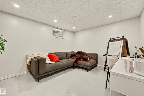 Recessed lighting illuminates a versatile space with light gray walls and a drop ceiling - 24 Addison Crescent, St. Albert, AB 