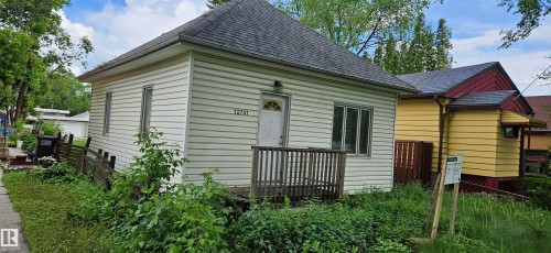 Single-story residence featuring light-colored siding and a dark shingle roof - 12741 117 Street Nw, Edmonton, AB 