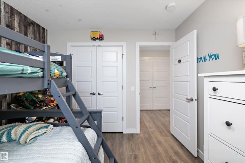 Neutral tone wall paint with wood-finish flooring - 363 Cy Becker Boulevard, Edmonton, AB - Indoor Photo Showing Other Room