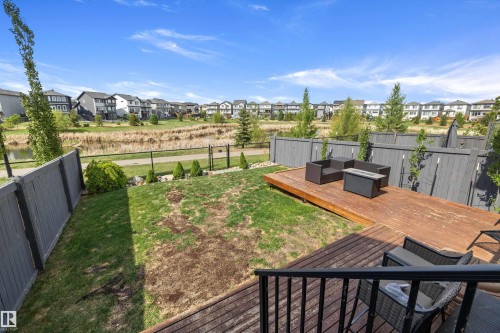 Expansive backyard featuring a multi-level wood-finish deck, a manicured lawn, and perimeter fencing - 363 Cy Becker Boulevard, Edmonton, AB - Outdoor With Deck Patio Veranda