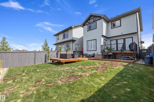 Rear exterior of the property featuring a light blue siding finish and dark trim - 363 Cy Becker Boulevard, Edmonton, AB - Outdoor With Deck Patio Veranda
