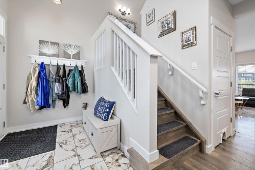 Inviting entryway featuring white-painted trim, a built-in coat rack, and a storage bench - 363 Cy Becker Boulevard, Edmonton, AB - Indoor Photo Showing Other Room