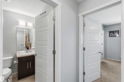 Bathroom vanity featuring a single sink, wood-finish cabinetry, and a countertop - 