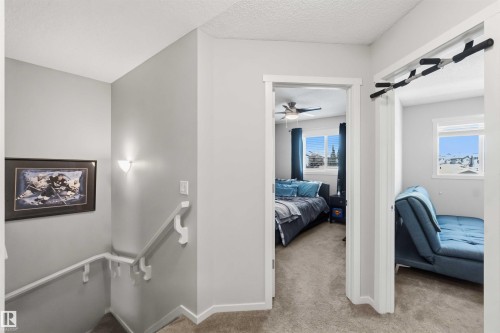 Upper-level hallway with neutral carpeting and light gray walls - 940 East Gate, Edmonton, AB 
