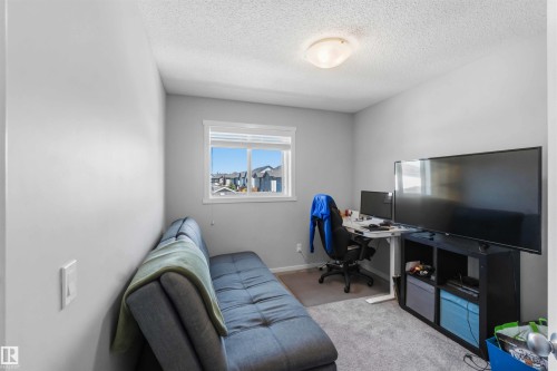 Bright room featuring a window with white trim, light gray walls, and textured ceiling - 940 East Gate, Edmonton, AB 