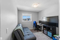 Bright room featuring a window with white trim, light gray walls, and textured ceiling - 