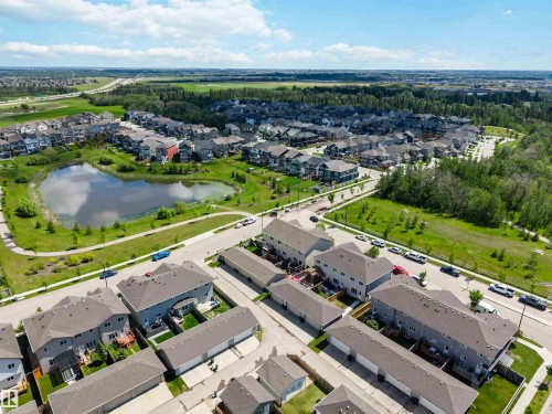 Aerial perspective of a residential neighborhood featuring detached homes and townhomes with attached rear garages - 940 East Gate, Edmonton, AB 