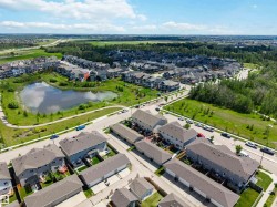 Aerial perspective of a residential neighborhood featuring detached homes and townhomes with attached rear garages - 