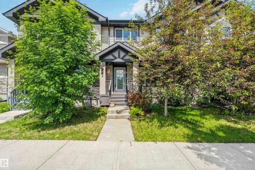 Townhome exterior featuring light-colored siding and dark trim accents - 940 East Gate, Edmonton, AB 