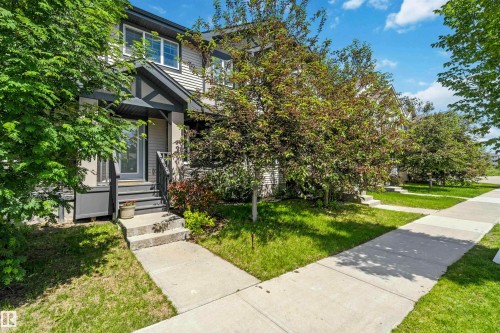 Two-story residence featuring light-toned siding and dark trim accents - 940 East Gate, Edmonton, AB 