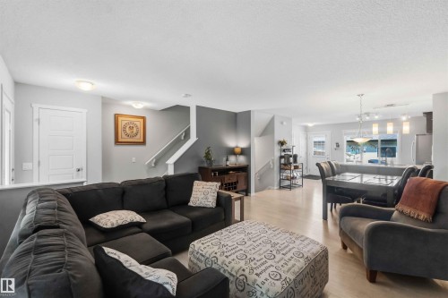Open-concept living space featuring light wood-finish flooring throughout - 940 East Gate, Edmonton, AB 