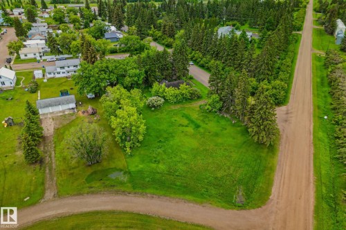 Expansive green space featuring mature trees and a dirt road frontage - 5305 51 Street, Willingdon, AB 