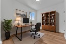 Flexible space featuring light wood-finish flooring, white walls, and a window providing natural light - 501 Creekside Bay, Leduc, AB 