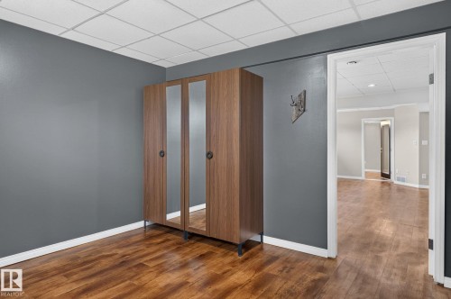 Wood-finish flooring with crisp white baseboards and contemporary gray wall paint - 86 Heritage Crescent, Stony Plain, AB 