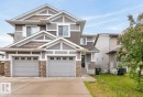 Contemporary exterior featuring multiple gables, gray siding, and brown shake accents - 12032 167B Avenue, Edmonton, AB 