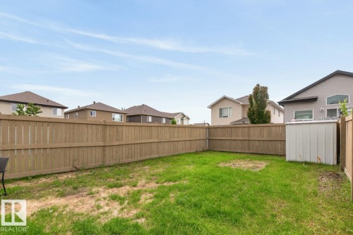 Expansive backyard featuring a wood fence perimeter and a metal storage shed - 12032 167B Avenue, Edmonton, AB 