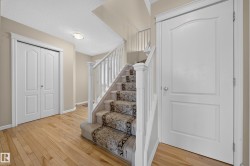 Staircase with patterned runner and white balusters - 