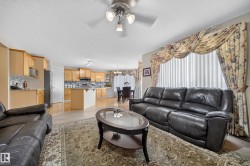 Open-concept living area featuring wood-finish flooring, recessed lighting, and a ceiling fan - 
