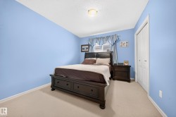 Carpeted bedroom with light blue walls and white trim - 