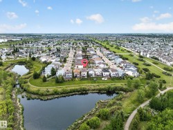 Aerial perspective showcasing a residential neighborhood with numerous homes and streets - 