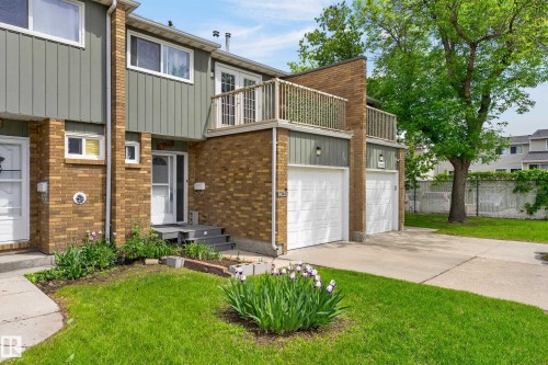 Brick and vertical siding exterior with twin garage doors - 13445 40 Street Nw, Edmonton, AB 