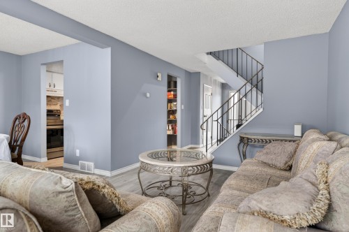 Interior space featuring light blue walls and wood-finish flooring - 13445 40 Street Nw, Edmonton, AB 