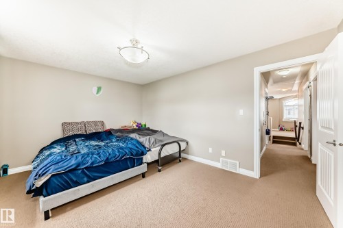 Carpeted room with neutral wall paint and a flush-mount ceiling light fixture - 5308 164 Avenue, Edmonton, AB 