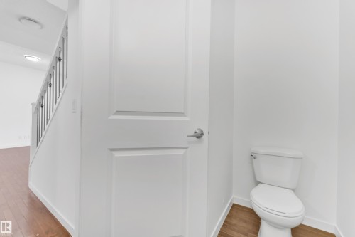 White paneled interior door with brushed nickel hardware - 5432 20 Avenue, Edmonton, AB 