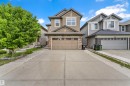 Two-story residence featuring a neutral-toned siding facade, stone accenting, and a gabled roofline - 5432 20 Avenue, Edmonton, AB 