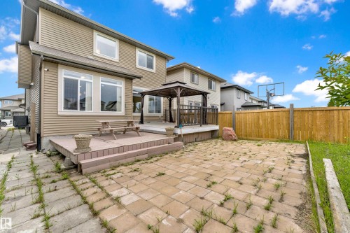 Rear exterior featuring a multi-level deck with a gazebo, paver patio, and wood privacy fencing - 5432 20 Avenue, Edmonton, AB 