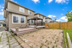 Rear exterior featuring a multi-level deck with a gazebo, paver patio, and wood privacy fencing - 