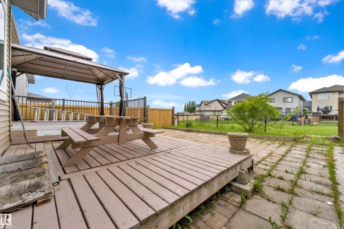 Expansive backyard deck featuring a gazebo structure, wood picket fencing, and chain link fencing - 5432 20 Avenue, Edmonton, AB 