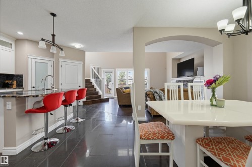 Open-concept living space with dark tile flooring - 21928 97 Avenue, Edmonton, AB 