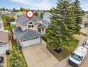Two-story residence featuring a two-car garage, concrete driveway, and established front landscaping - 4465 32A Street, Edmonton, AB 