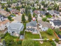 Aerial view showcasing a residential property with a multi-level deck overlooking a spacious lawn - 4465 32A Street, Edmonton, AB 