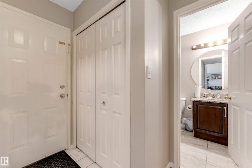 Entryway featuring a paneled door, bi-fold closet doors, and tile flooring - 4465 32A Street, Edmonton, AB 
