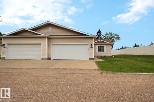 Two-car garage with overhead doors and concrete driveway - 8146 27 Avenue, Edmonton, AB - Outdoor