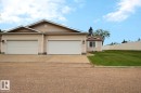 Two-car garage with overhead doors and concrete driveway - 8146 27 Avenue, Edmonton, AB  - Outdoor 