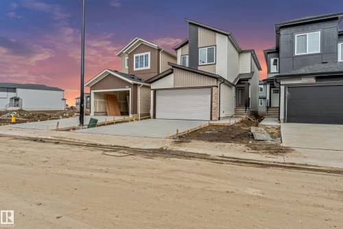 Contemporary two-story exterior with varied siding, a single-car garage, and a concrete driveway - 4636 18 Avenue, Edmonton, AB 