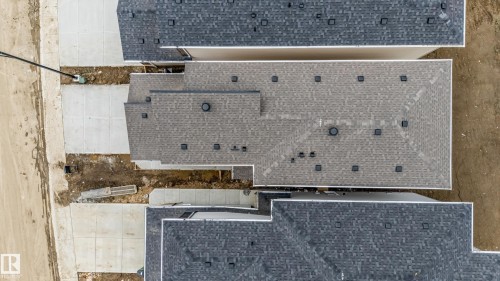 Two properties featuring asphalt shingle roofing and white eaves - 4636 18 Avenue, Edmonton, AB 