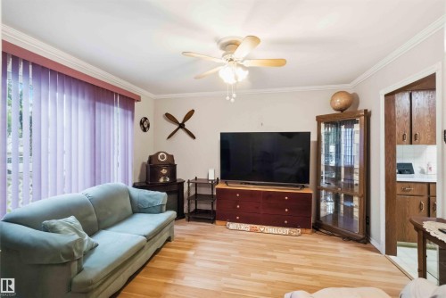 Light wood-finish flooring complements the neutral wall tones - 12016 61 Street, Edmonton, AB 