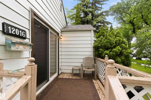 Exterior siding with a sliding glass door and outdoor lighting - 12016 61 Street, Edmonton, AB 