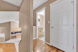 Hardwood-finish flooring extending into a bright hallway - 