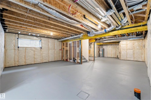 Spacious unfinished basement featuring exposed ceiling joists, insulated walls, and a painted concrete floor - 24 Grayson Green, Stony Plain, AB 