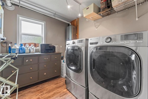 Dedicated laundry area featuring wood-finish flooring and neutral wall tones - 2602 Delta Road, Cold Lake, AB 